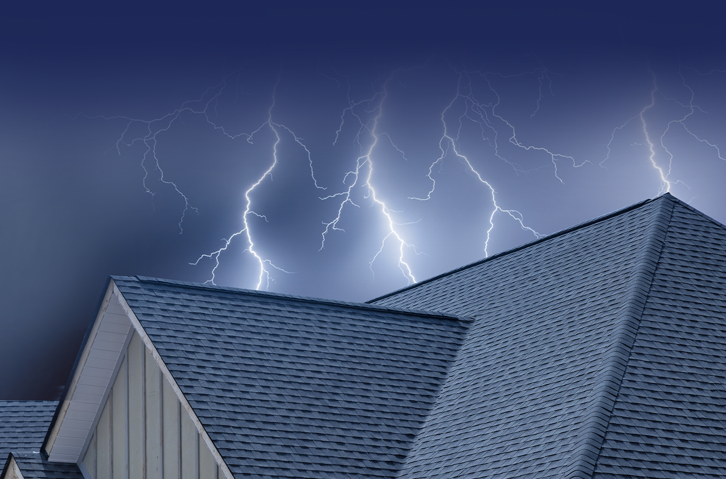 A roof with lightning coming down in the background